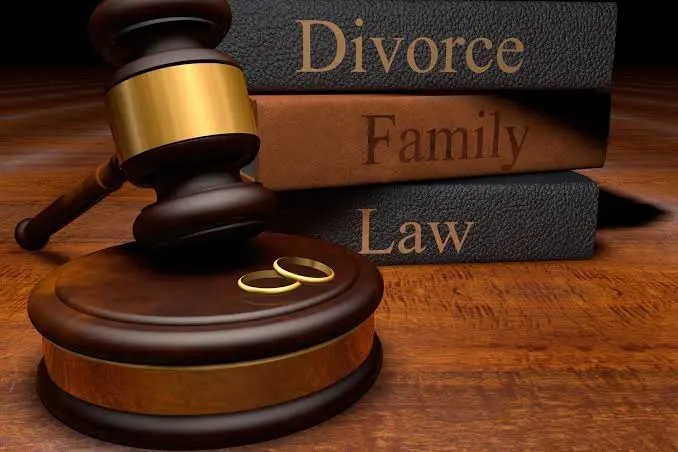 Family law attorney reviewing documents with a client at a desk